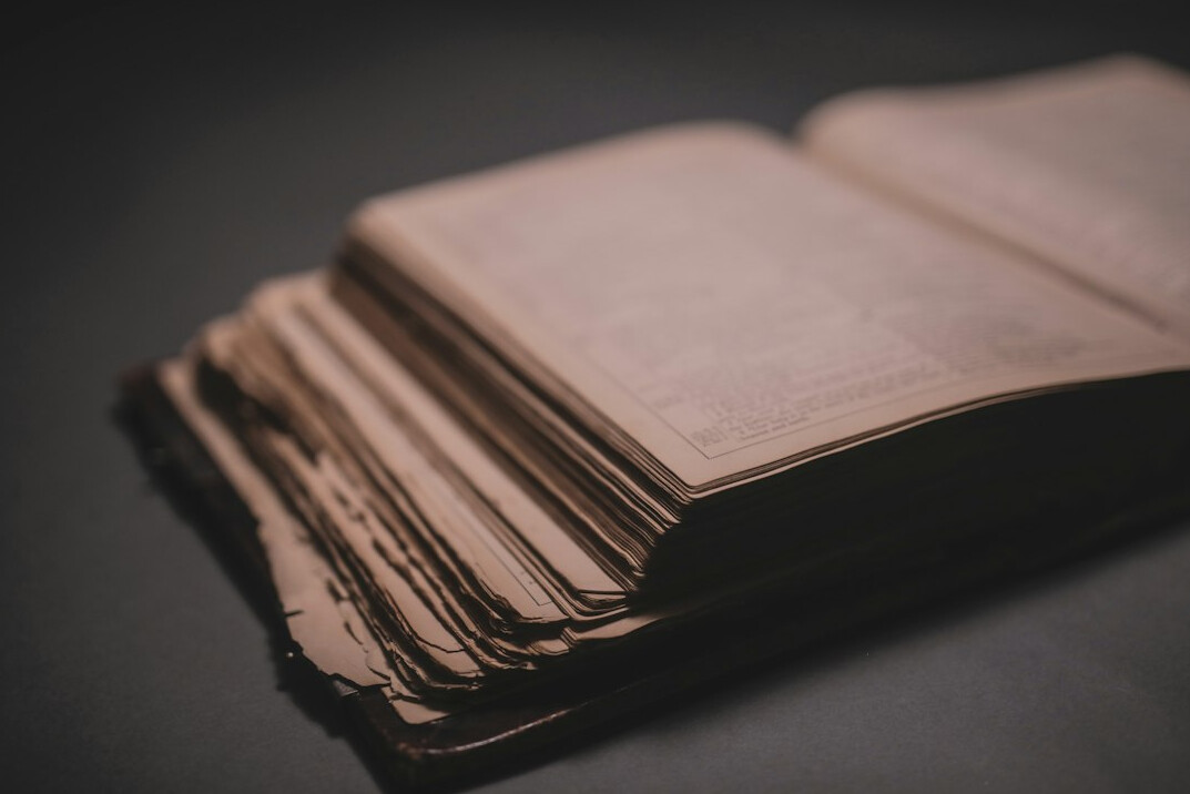Stack of aged documents and papers on a wooden desk